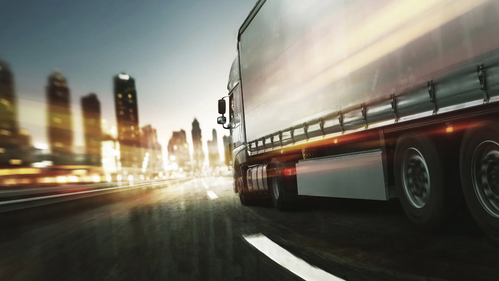 Commercial transport truck driving through Toronto at night, showcasing vehicle wrap potential by TorontoCarWrap.com