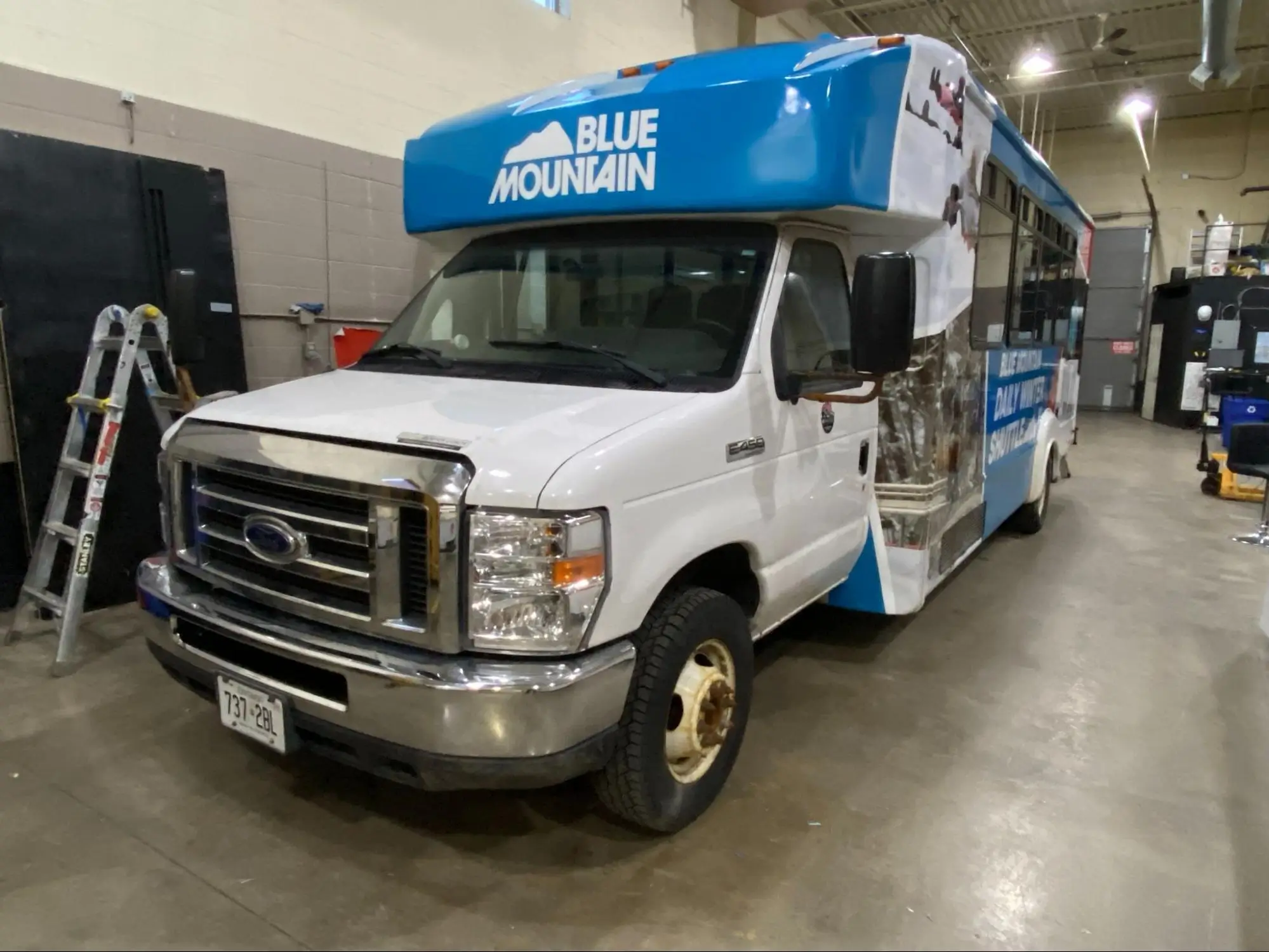Custom Blue Mountain shuttle bus wrap designed and installed at TorontoCarWrap.com's indoor vehicle wrapping facility