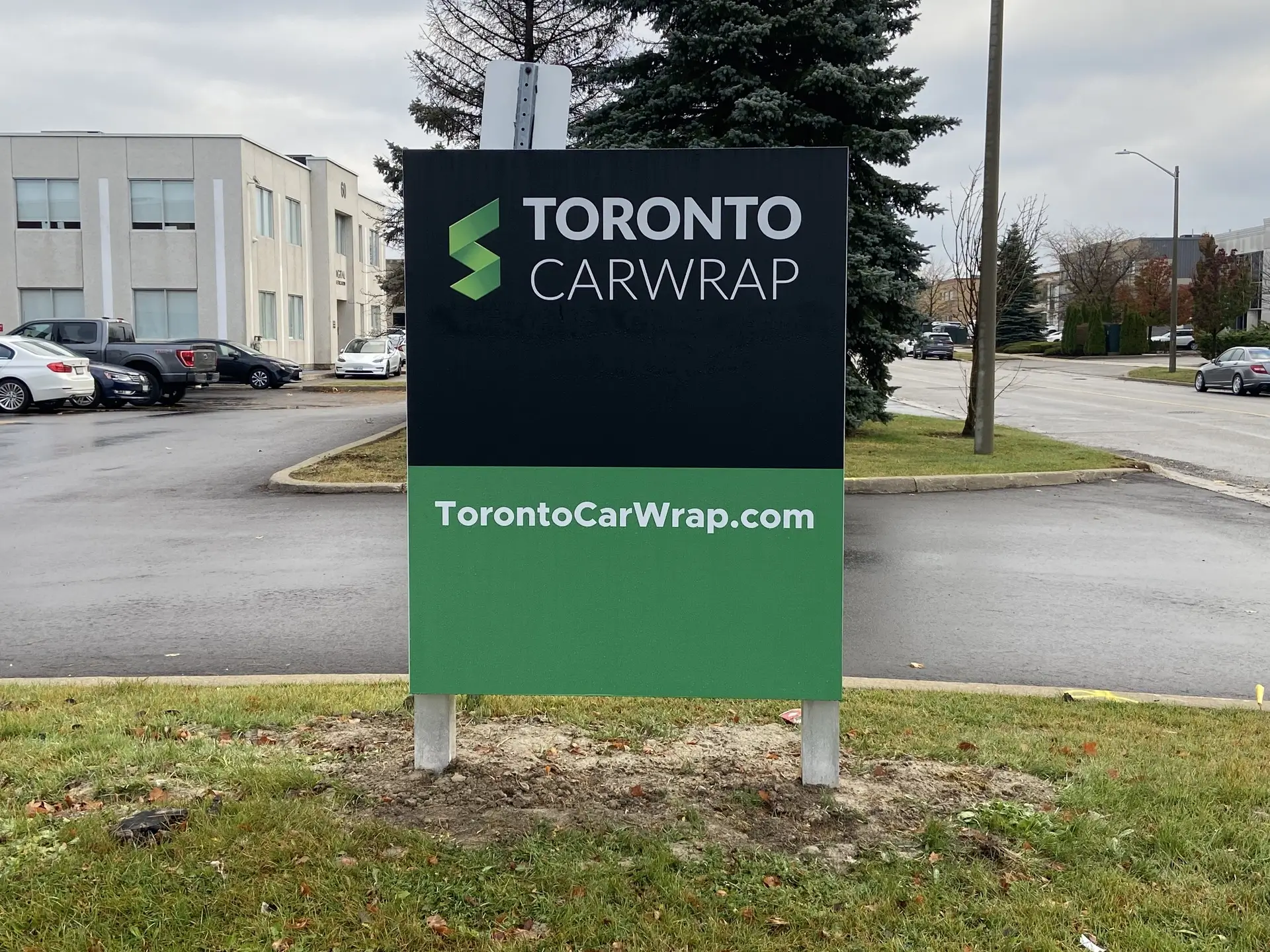Outdoor pylon sign displaying the Toronto Car Wrap logo and website URL, enhancing brand visibility at their business location.
